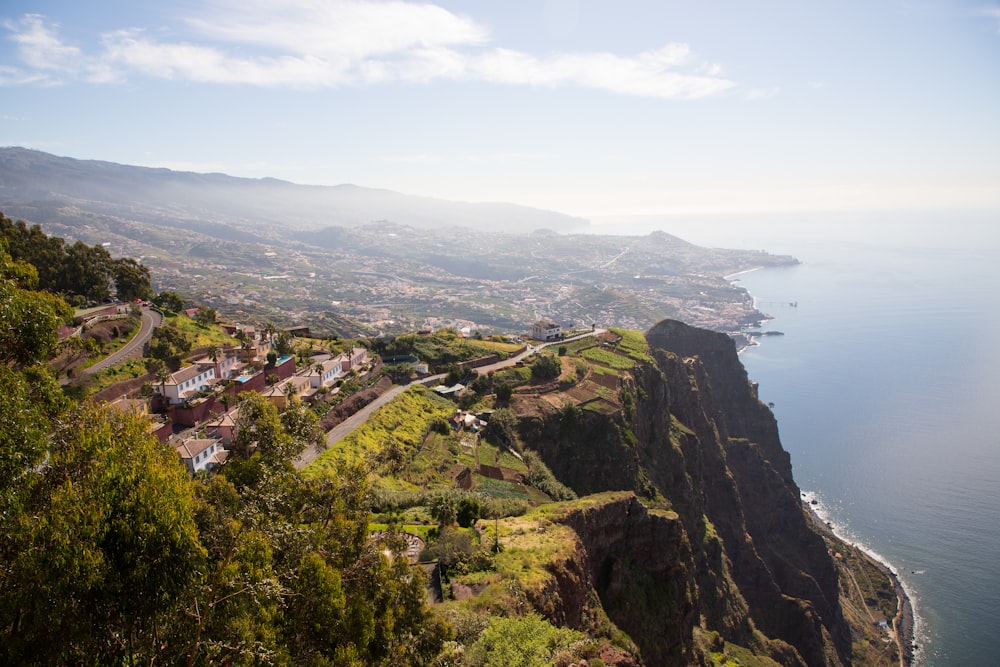 a scenic view of a town on the edge of a cliff