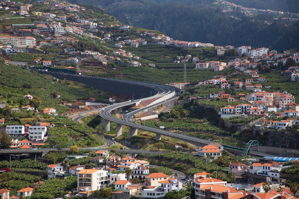 an aerial view of a city with a winding road