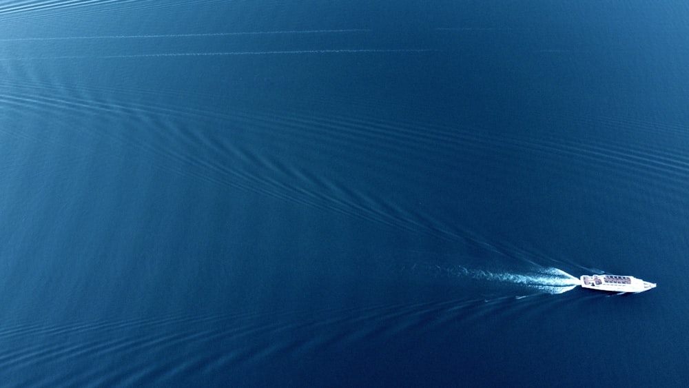 a small boat in the middle of a large body of water