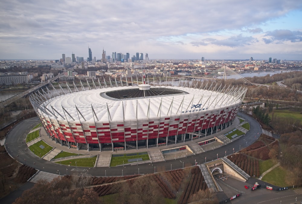 an aerial view of a soccer stadium with a city in the background