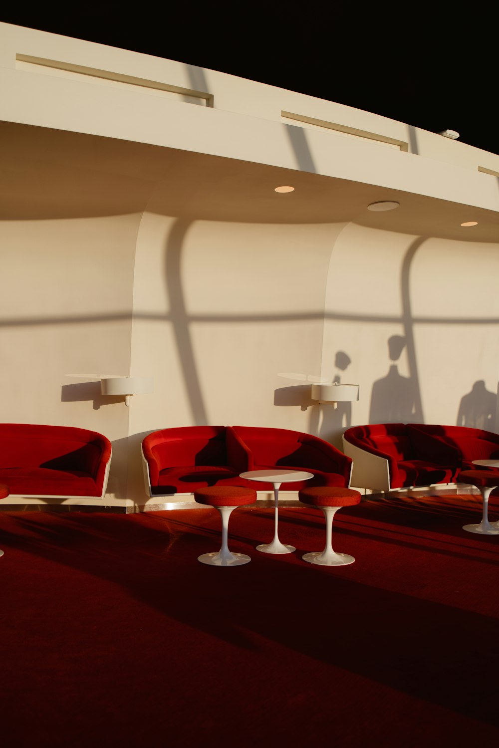 a group of red chairs sitting next to each other