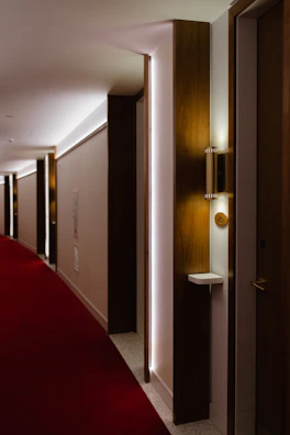 Stylish hotel corridor showcasing a blend of black charcoal and warm off-white walls.