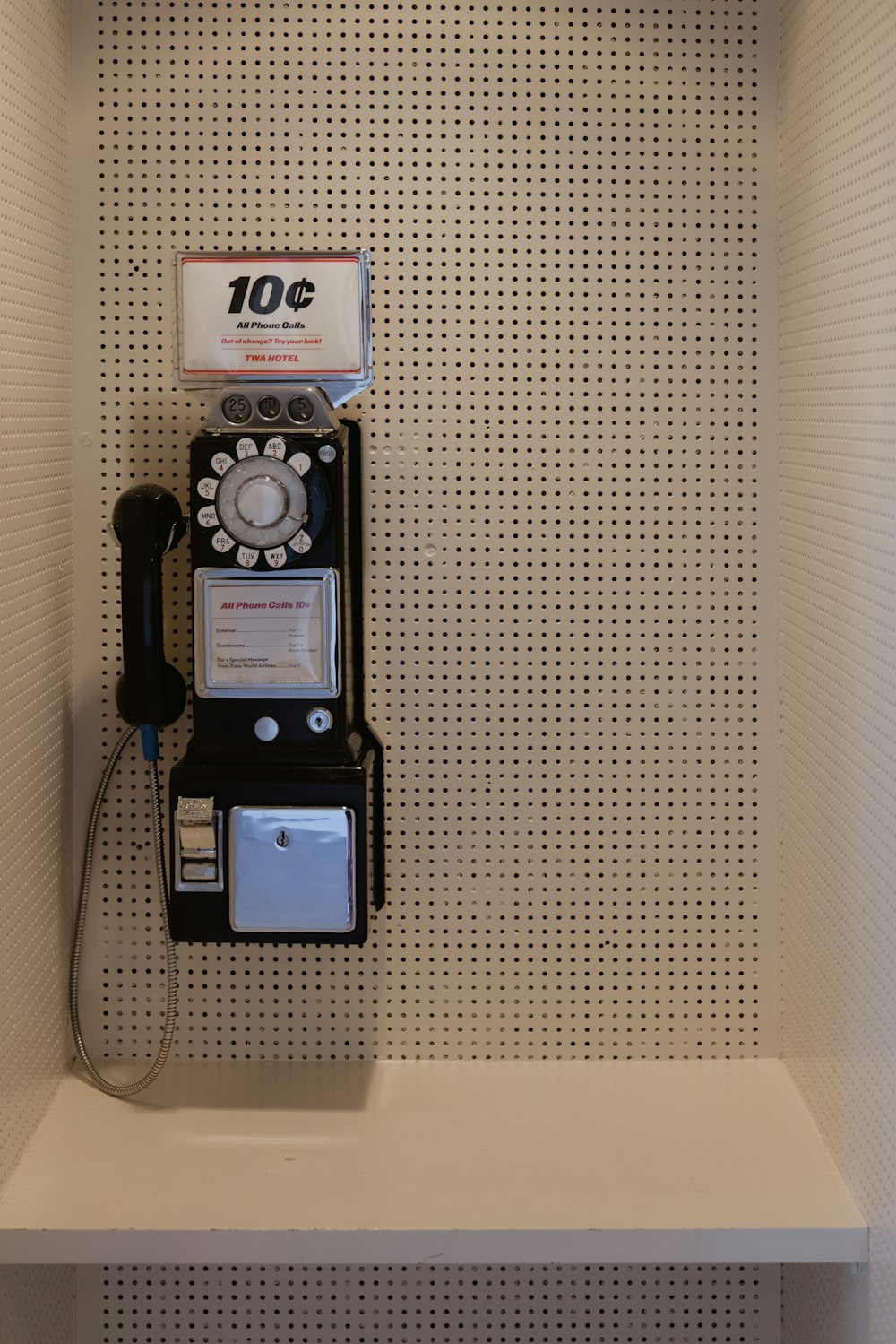 an old fashioned phone is on a shelf