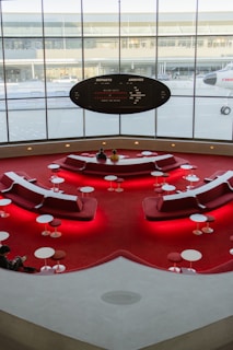 a room with a red carpet and a large window