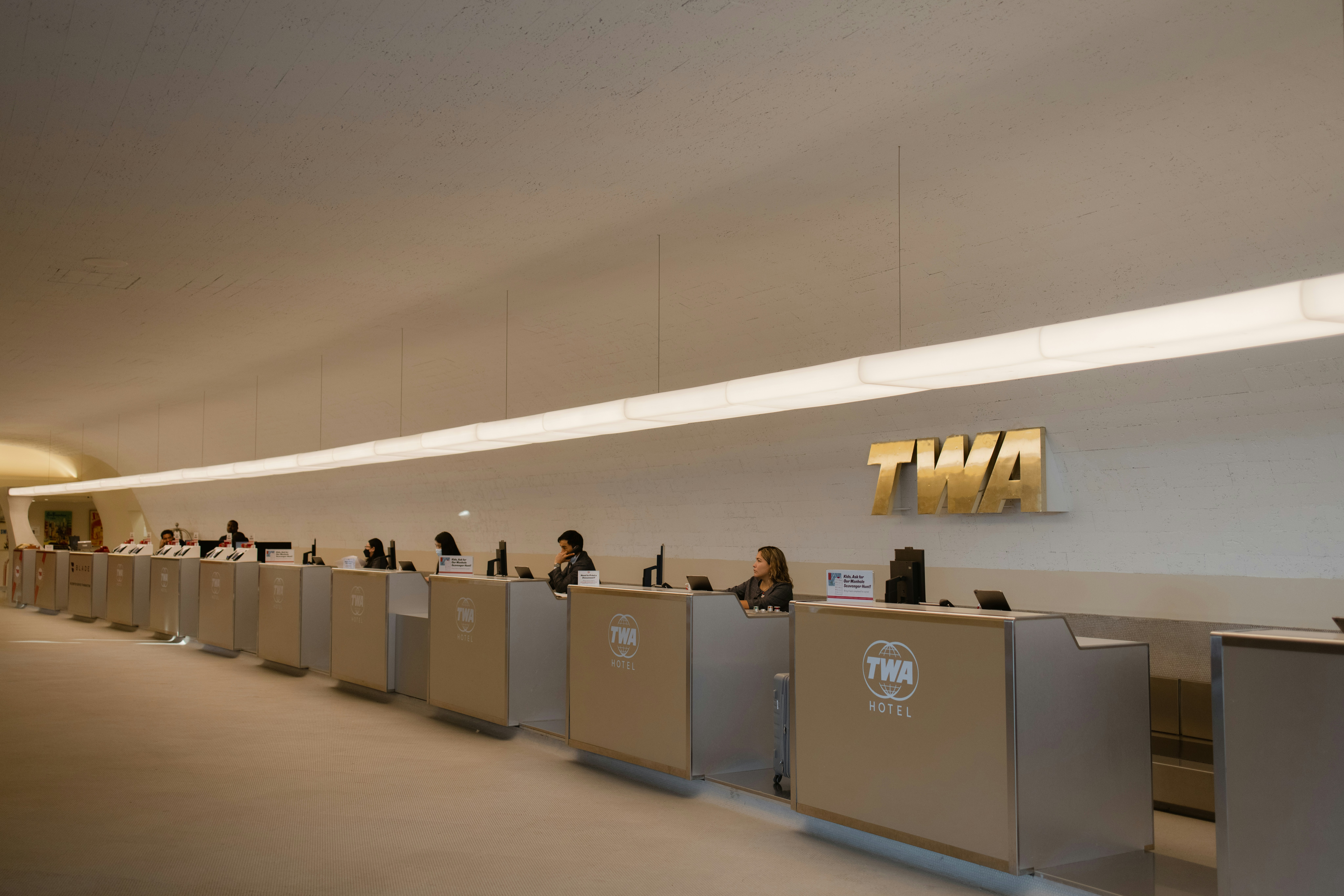 a group of people sitting at a long counter, 