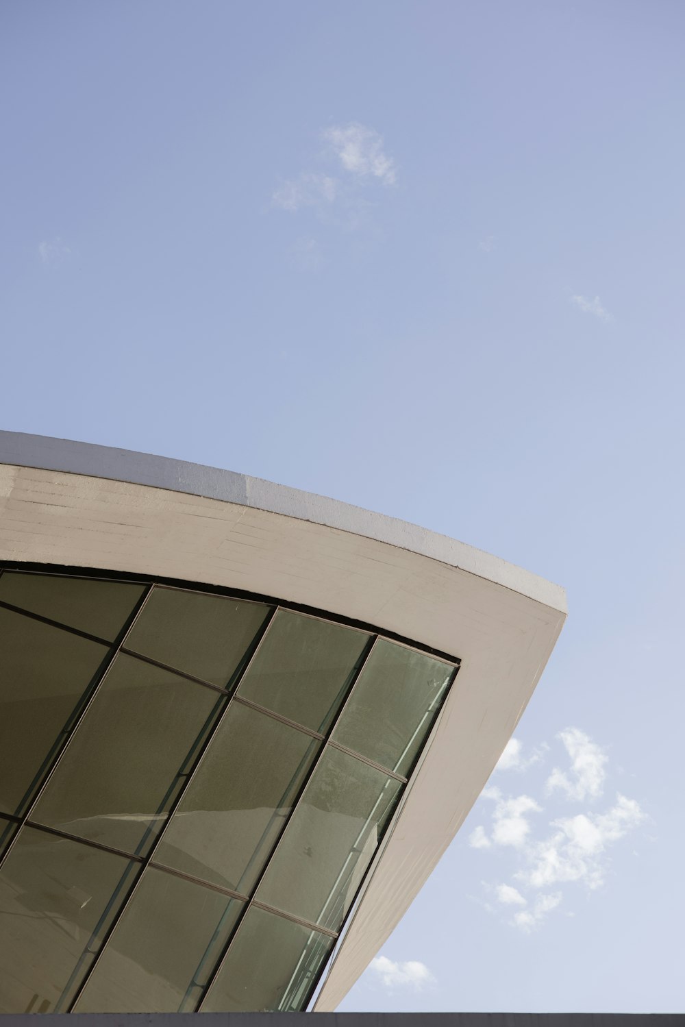 a clock on the side of a building with a sky background