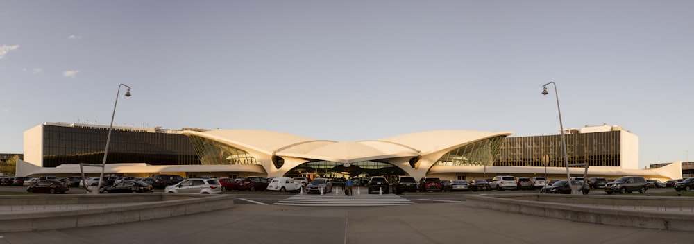 a large building with a lot of cars parked in front of it