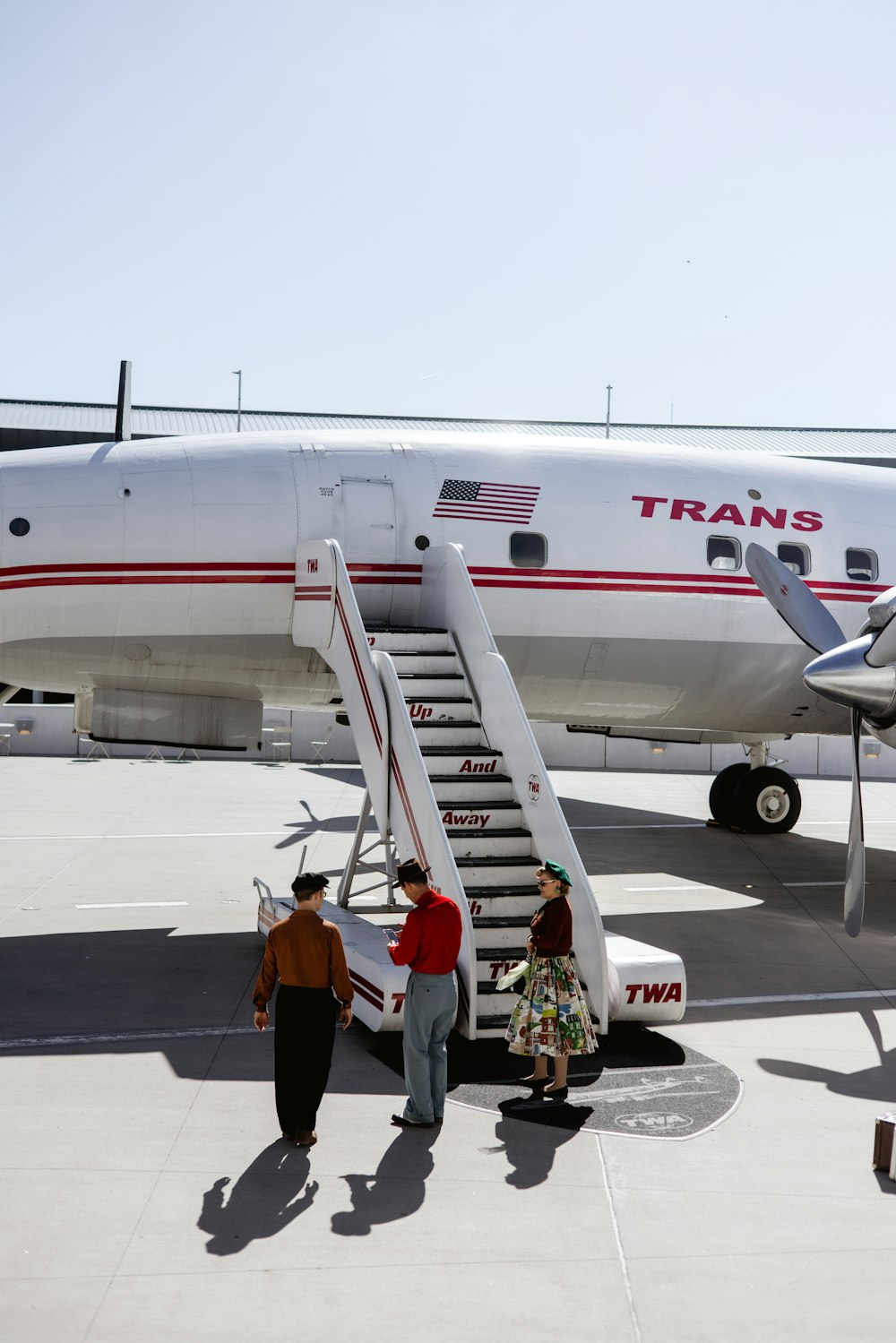 a group of people getting off of an airplane