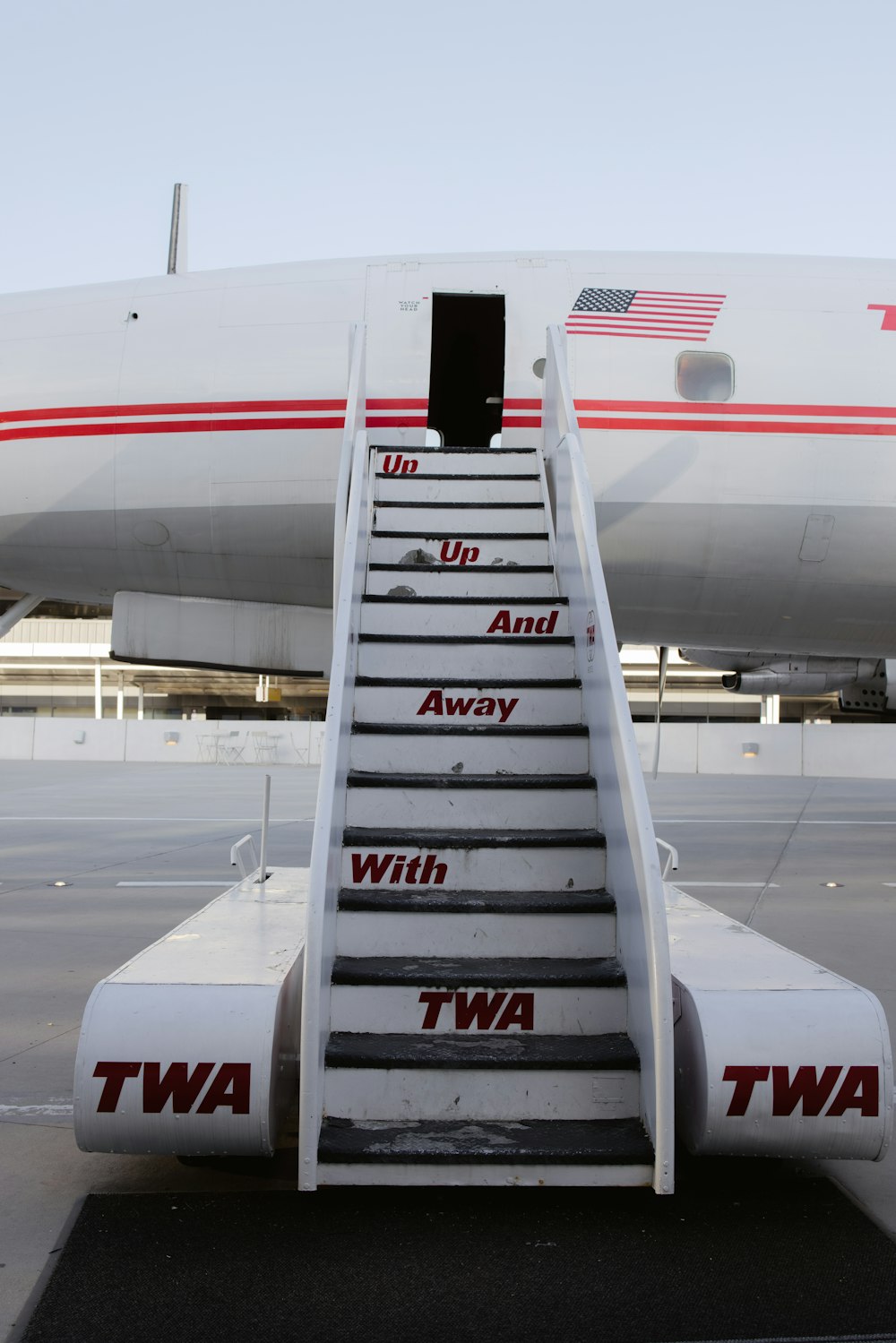 a white airplane with steps leading up to it