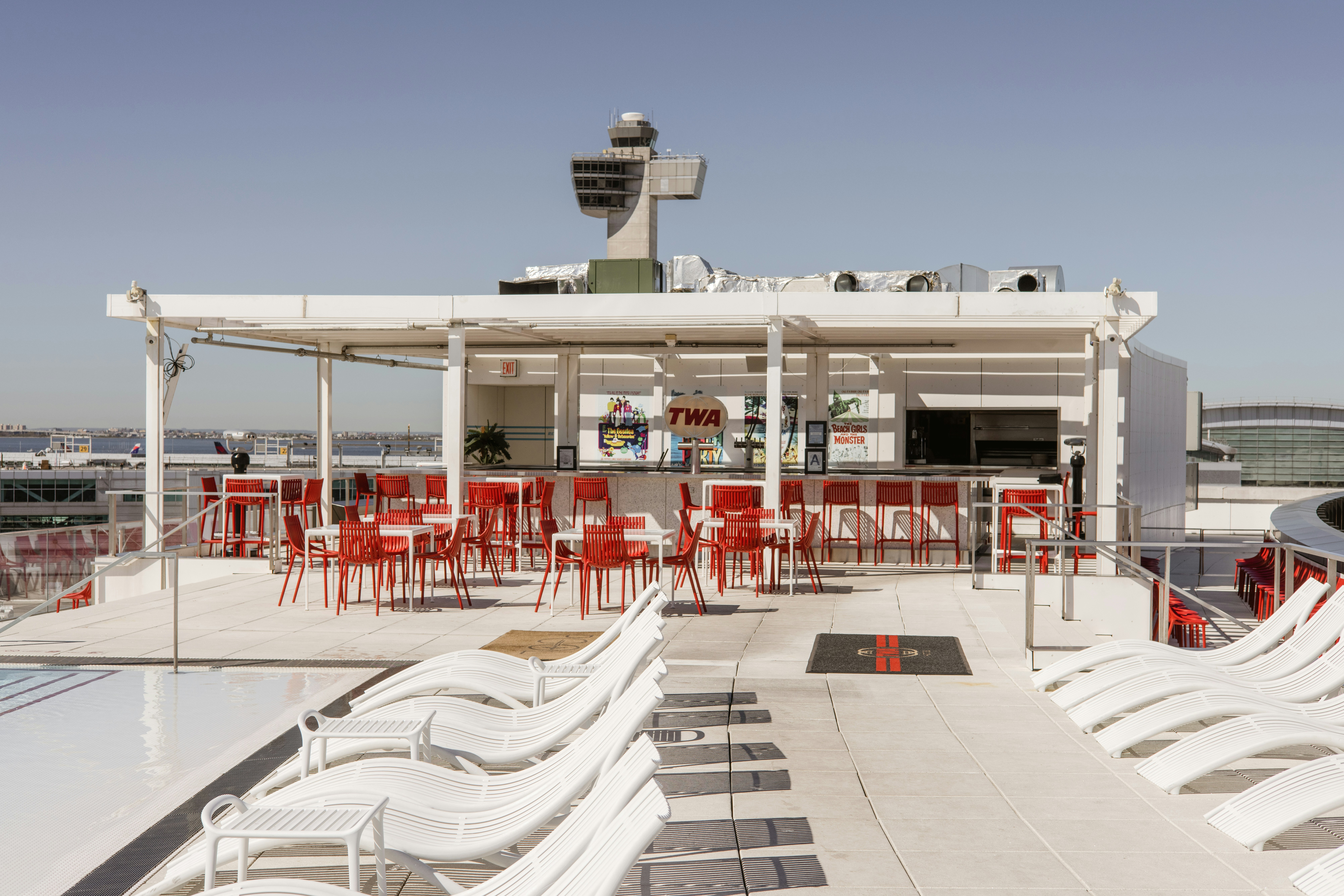 a group of red and white chairs sitting on top of a roof, 