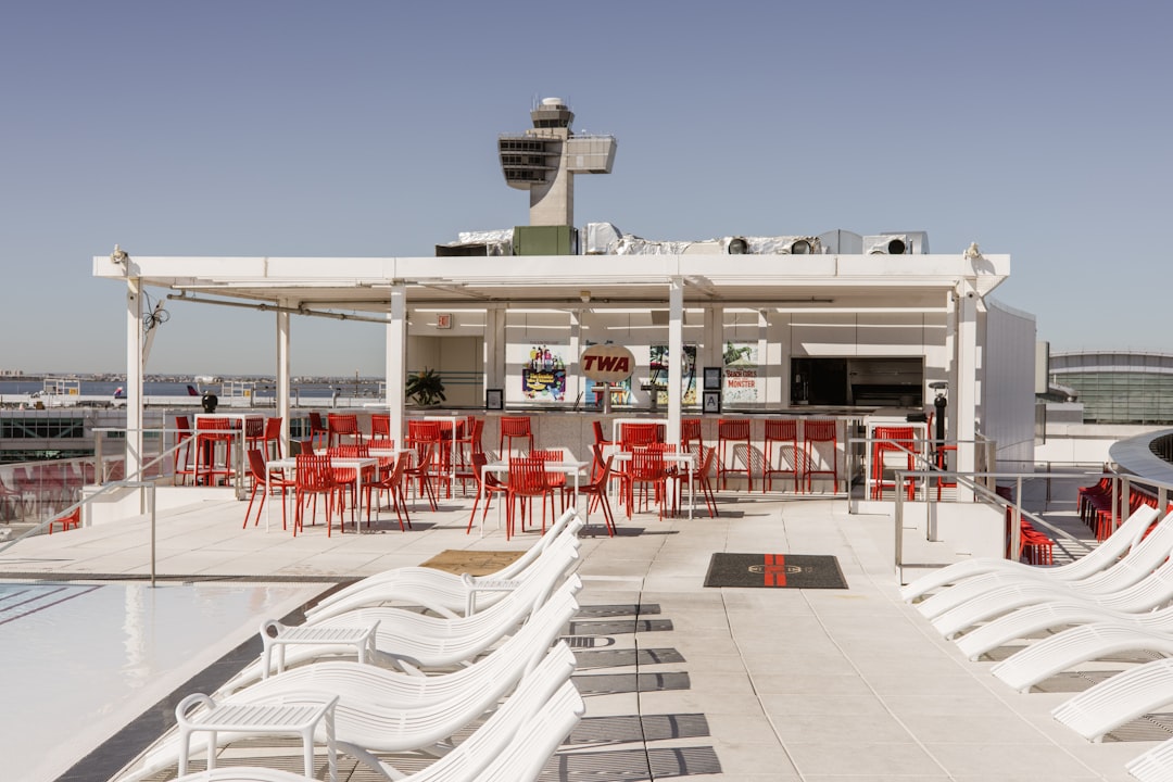 a group of red and white chairs sitting on top of a roof,