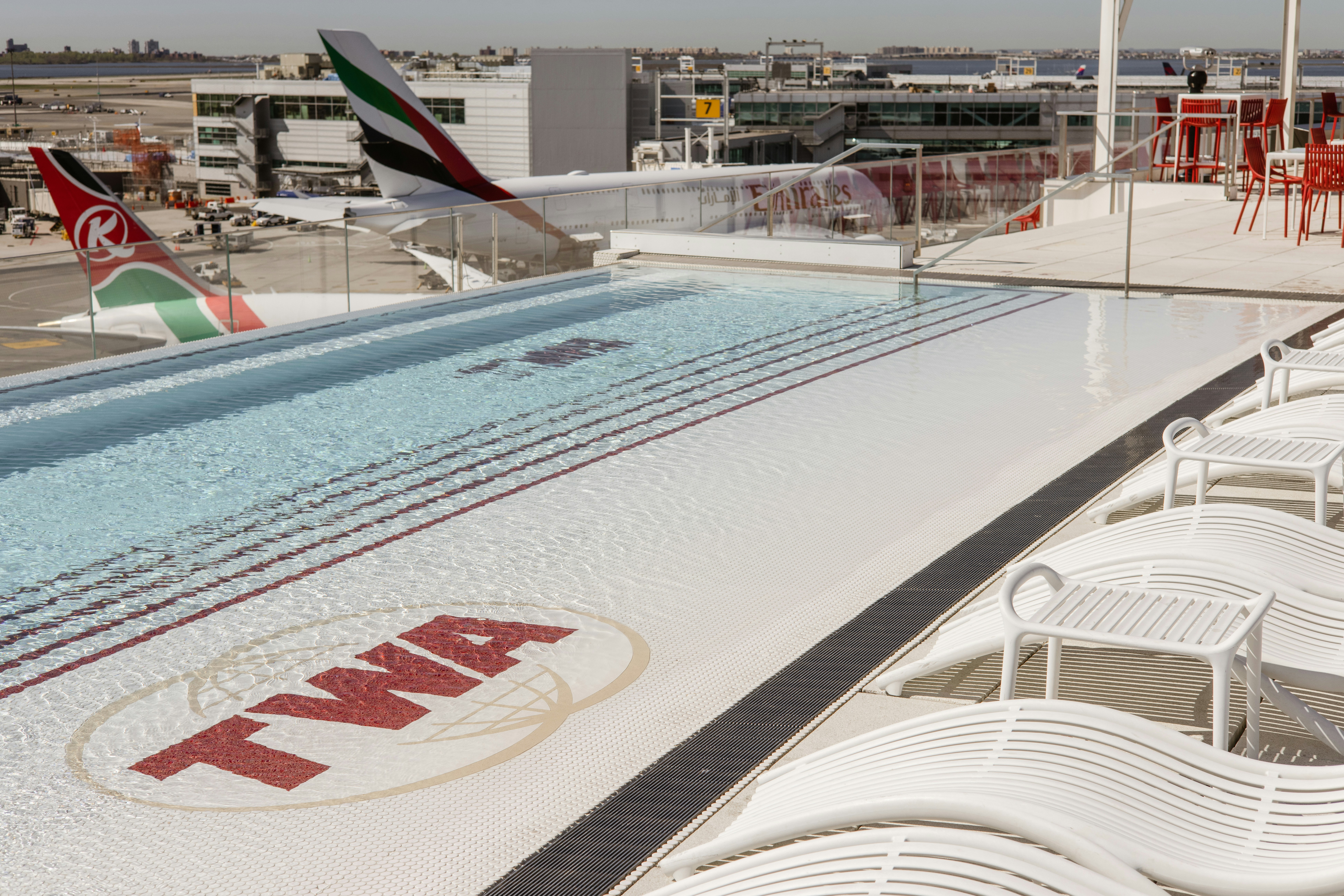 a large swimming pool on top of a building, 