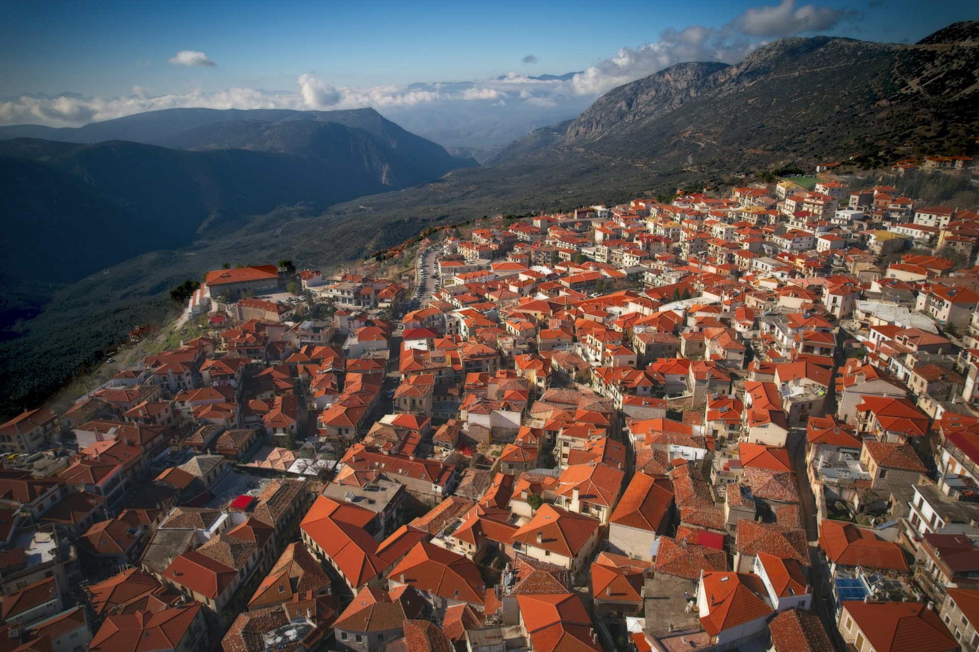 an aerial view of a city with mountains in the background