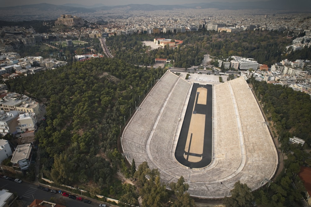 an aerial view of a stadium with trees in the foreground