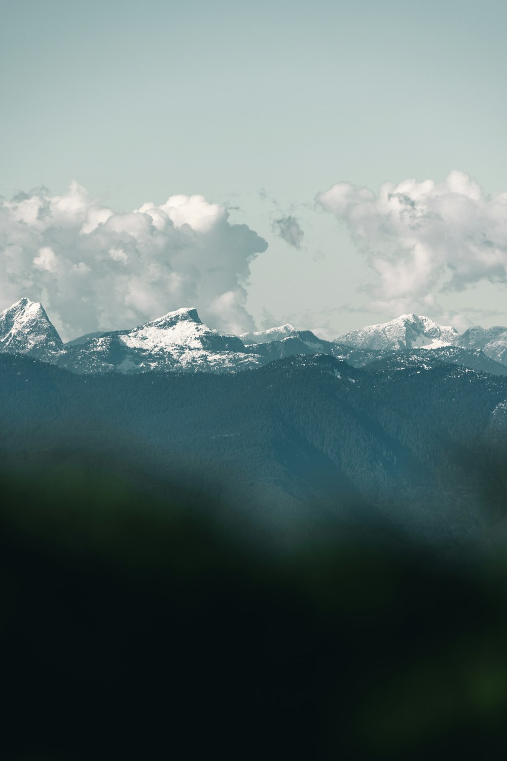 a view of a mountain range with clouds in the sky