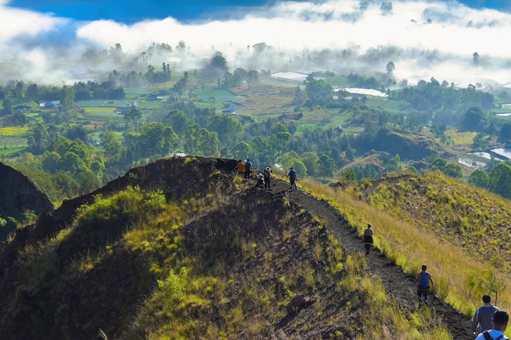 a group of people walking up the side of a mountain