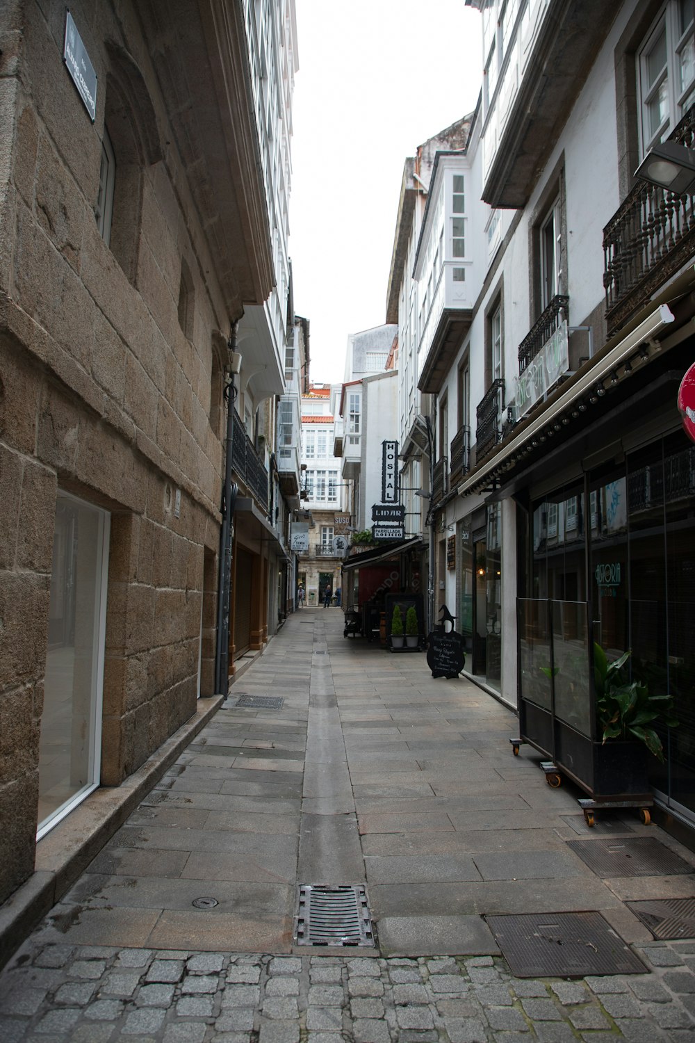 a narrow city street with buildings on both sides