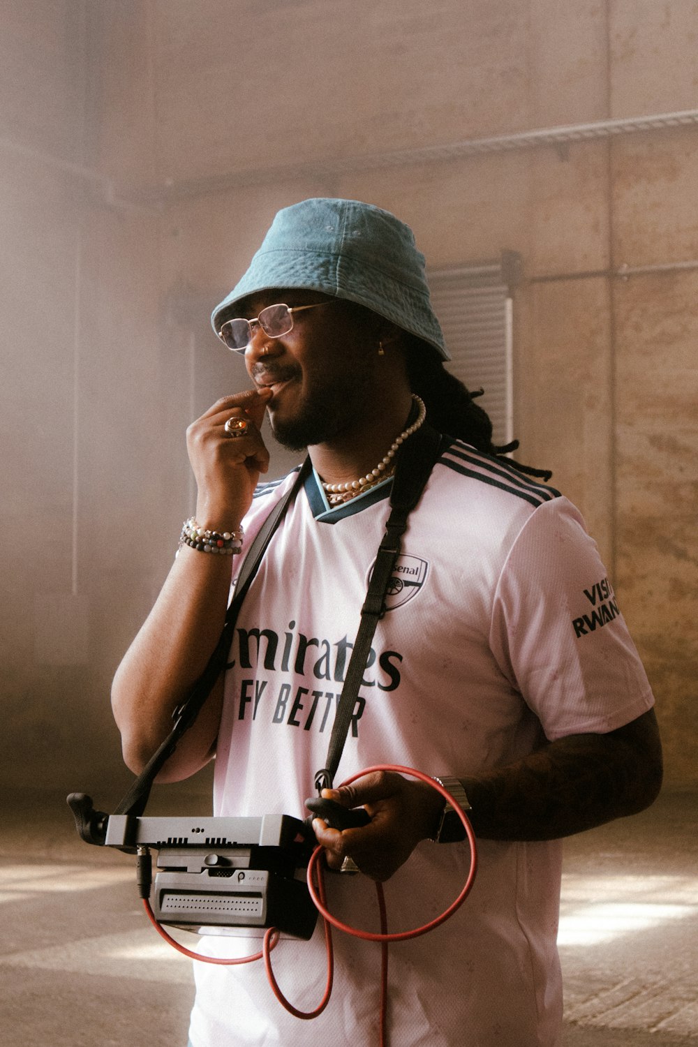 a man with dreadlocks talking on a cell phone