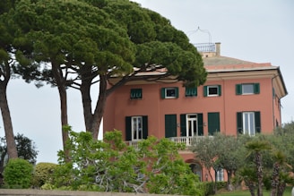 Cozy medium-value home with lush garden and peachy exterior walls.