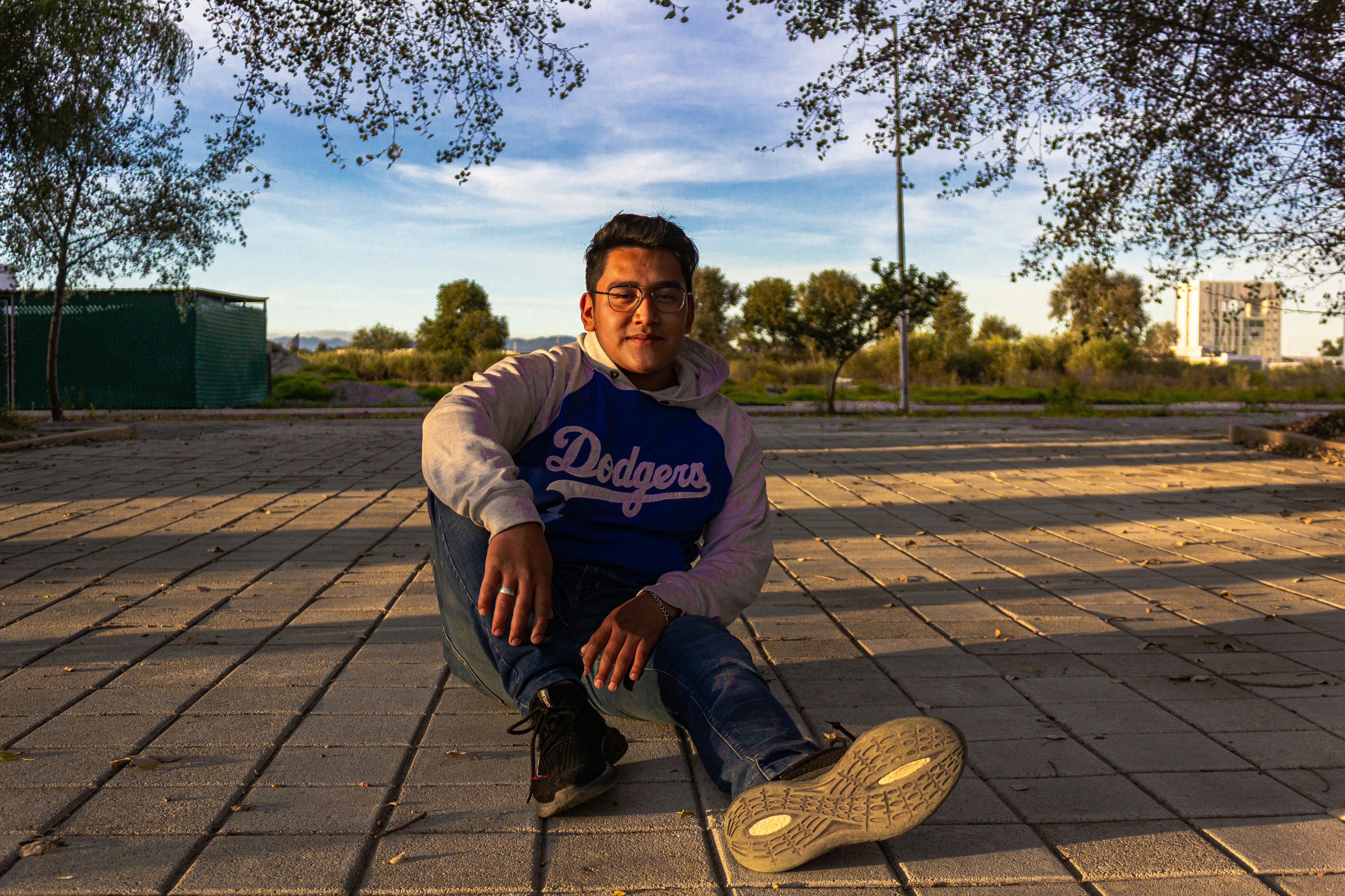 a man sitting on the ground with his foot on a shoe