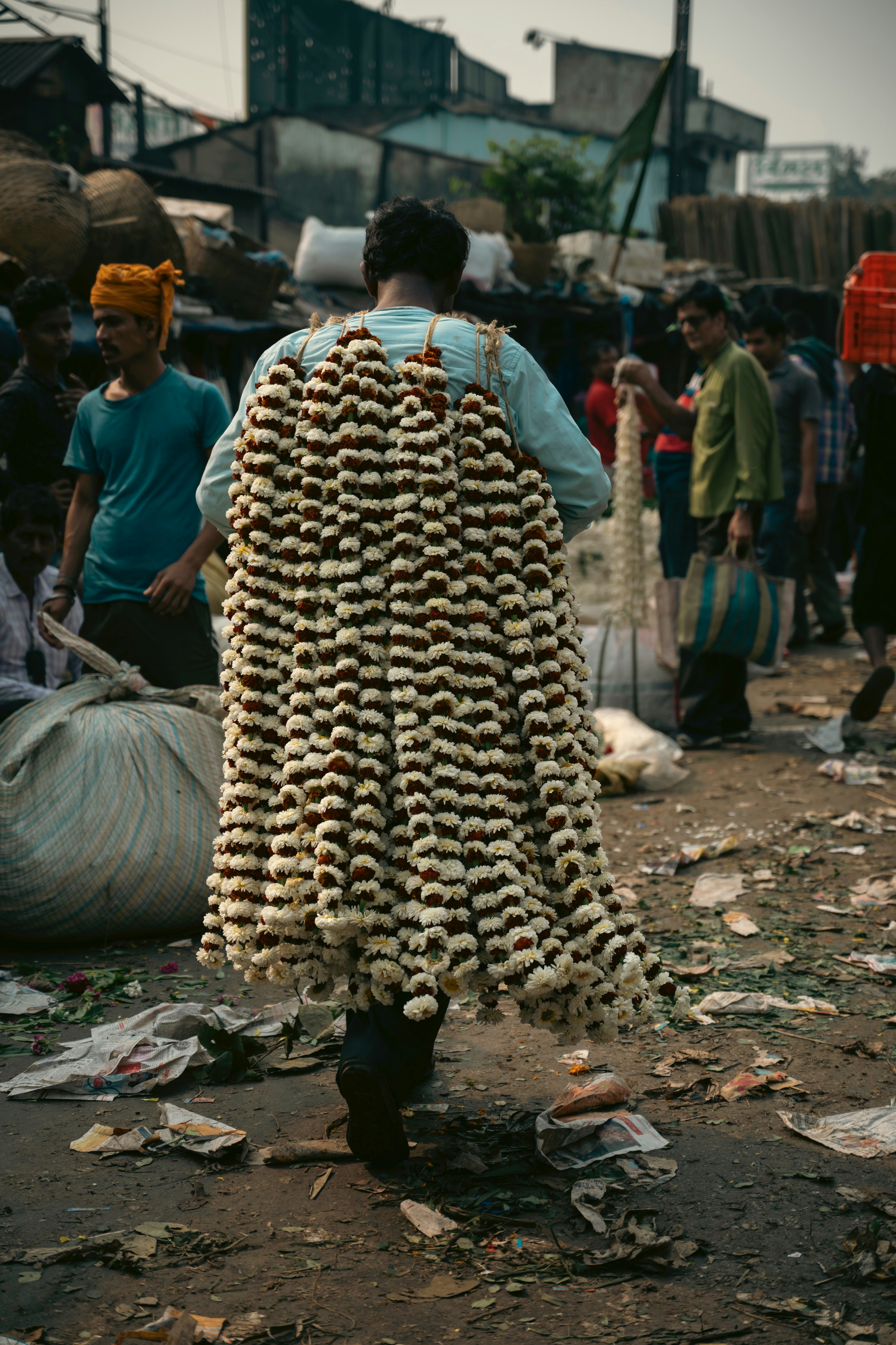a man walking down a street carrying a large amount of items