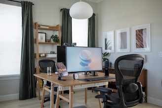 a desk with a computer and chair in a room