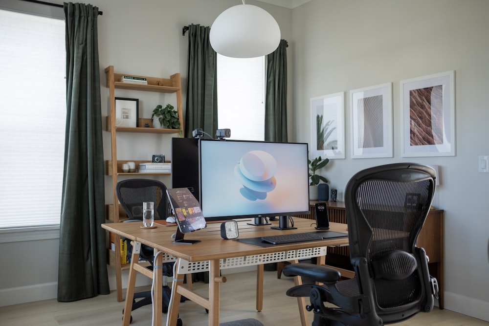 a desk with a computer and chair in a room