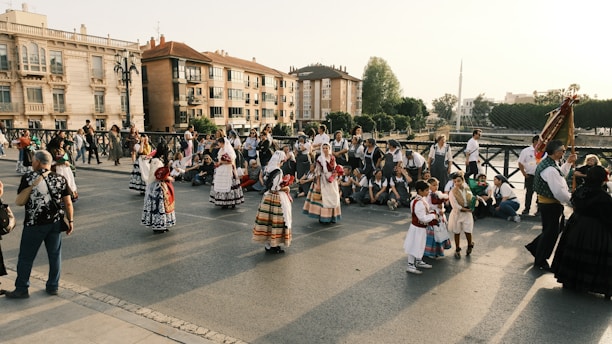 a group of people walking across a street