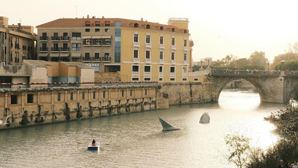 a person in a small boat on a river