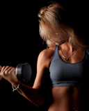 a woman in a sports bra holding a dumb