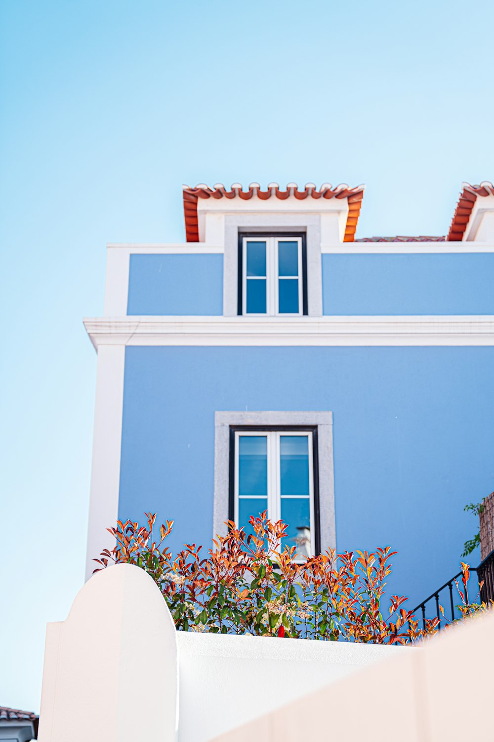 a blue and white building with a clock on it's side