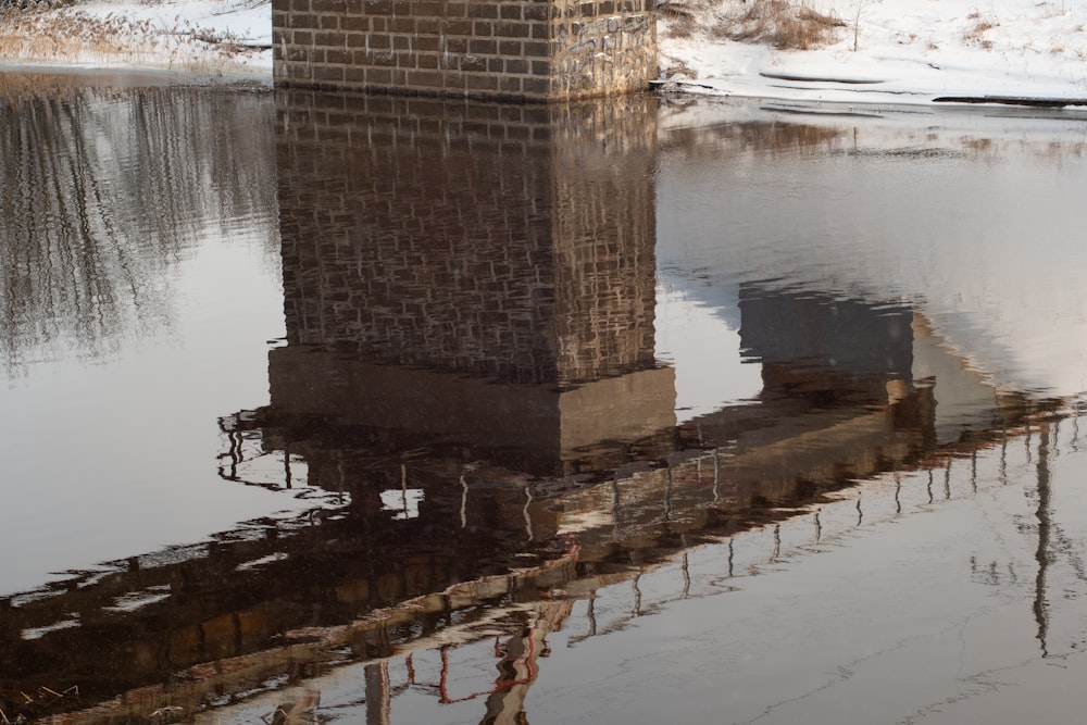 a tall tower sitting in the middle of a body of water