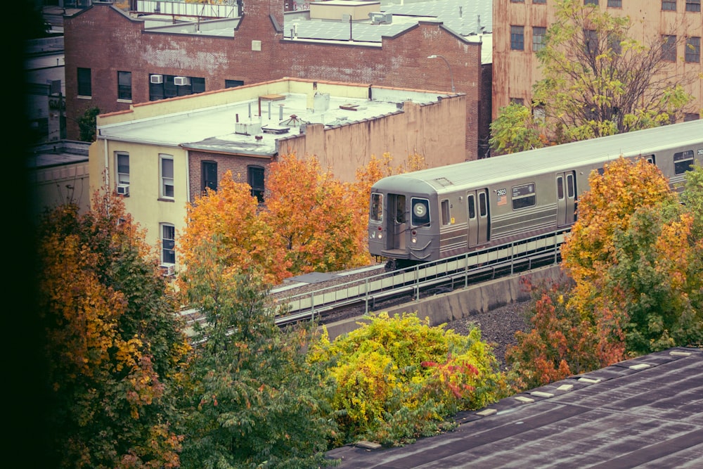 a train traveling through a city surrounded by tall buildings