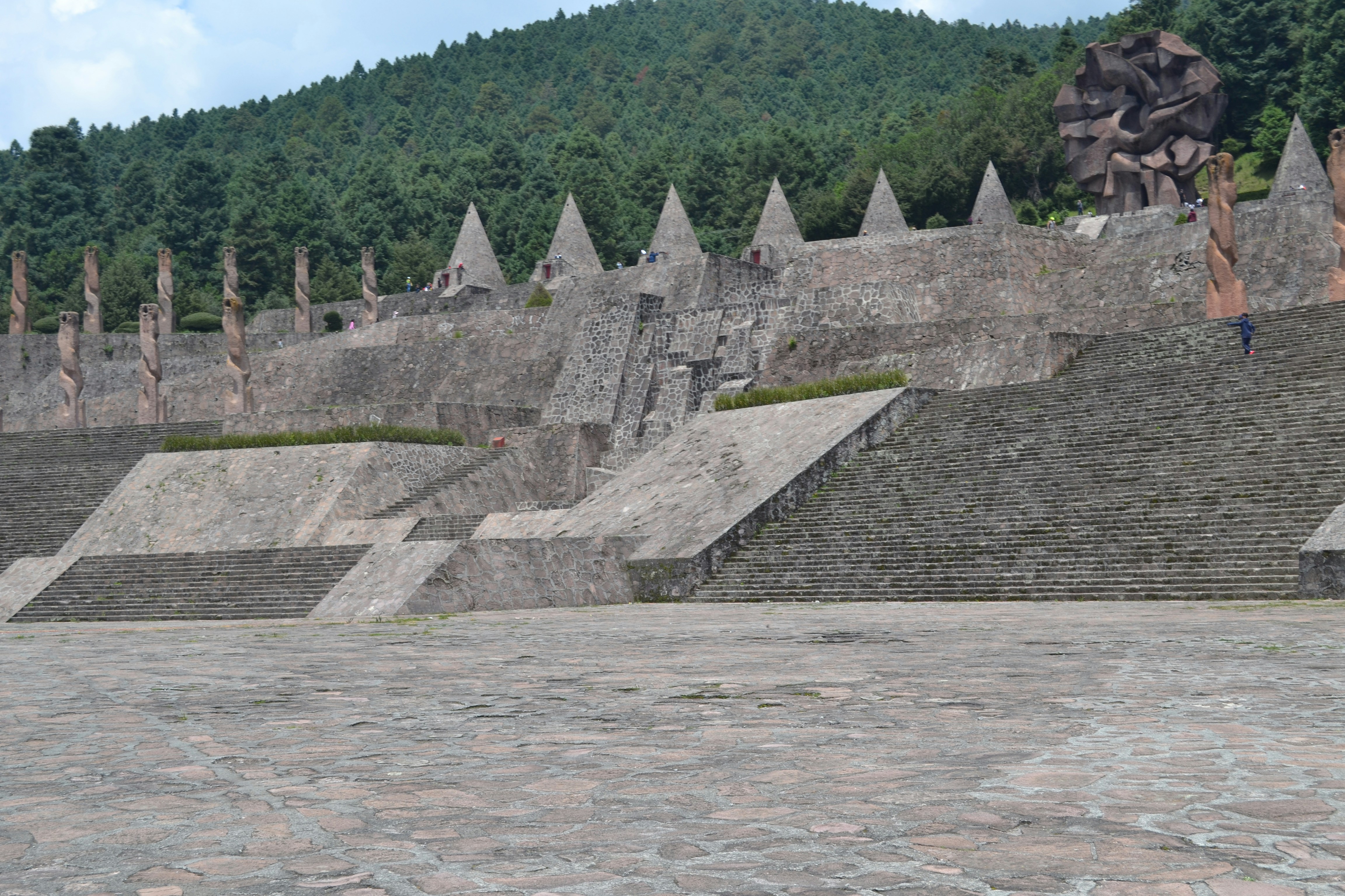 a man riding a skateboard down the side of a stone wall
