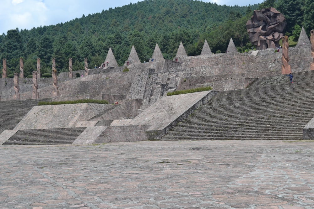 a man riding a skateboard down the side of a stone wall