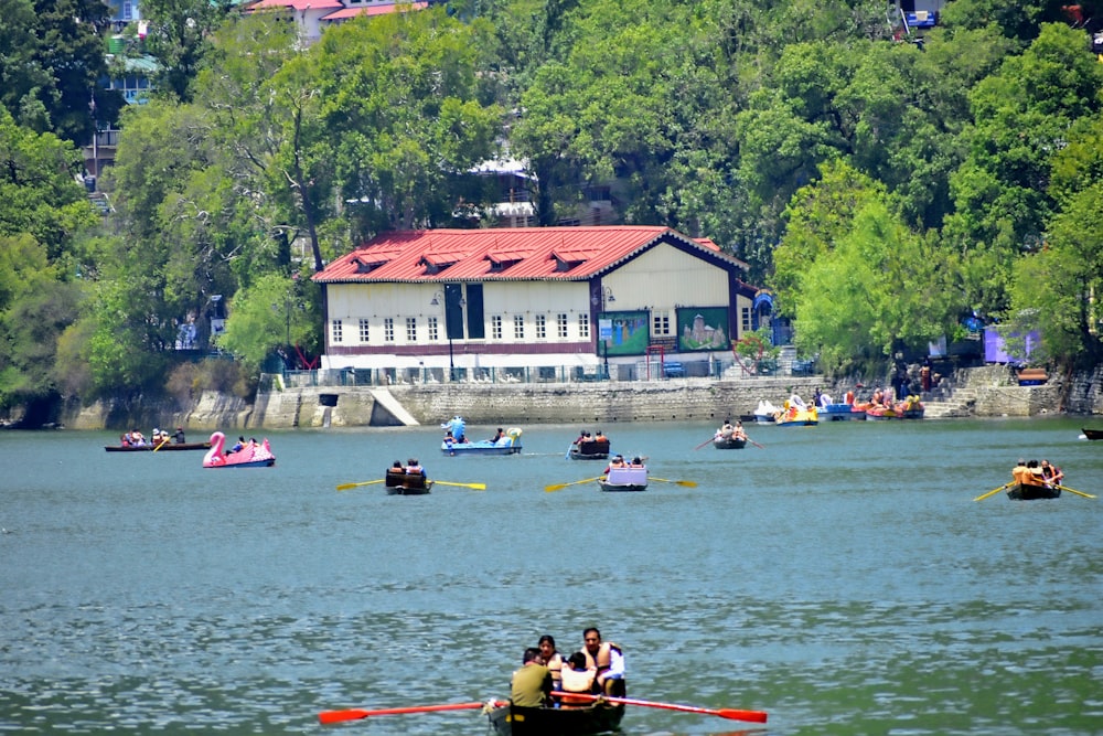 a group of people riding on top of a boat in a lake