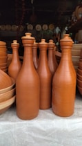 a group of brown vases sitting on top of a table