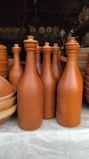 a group of brown vases sitting on top of a table