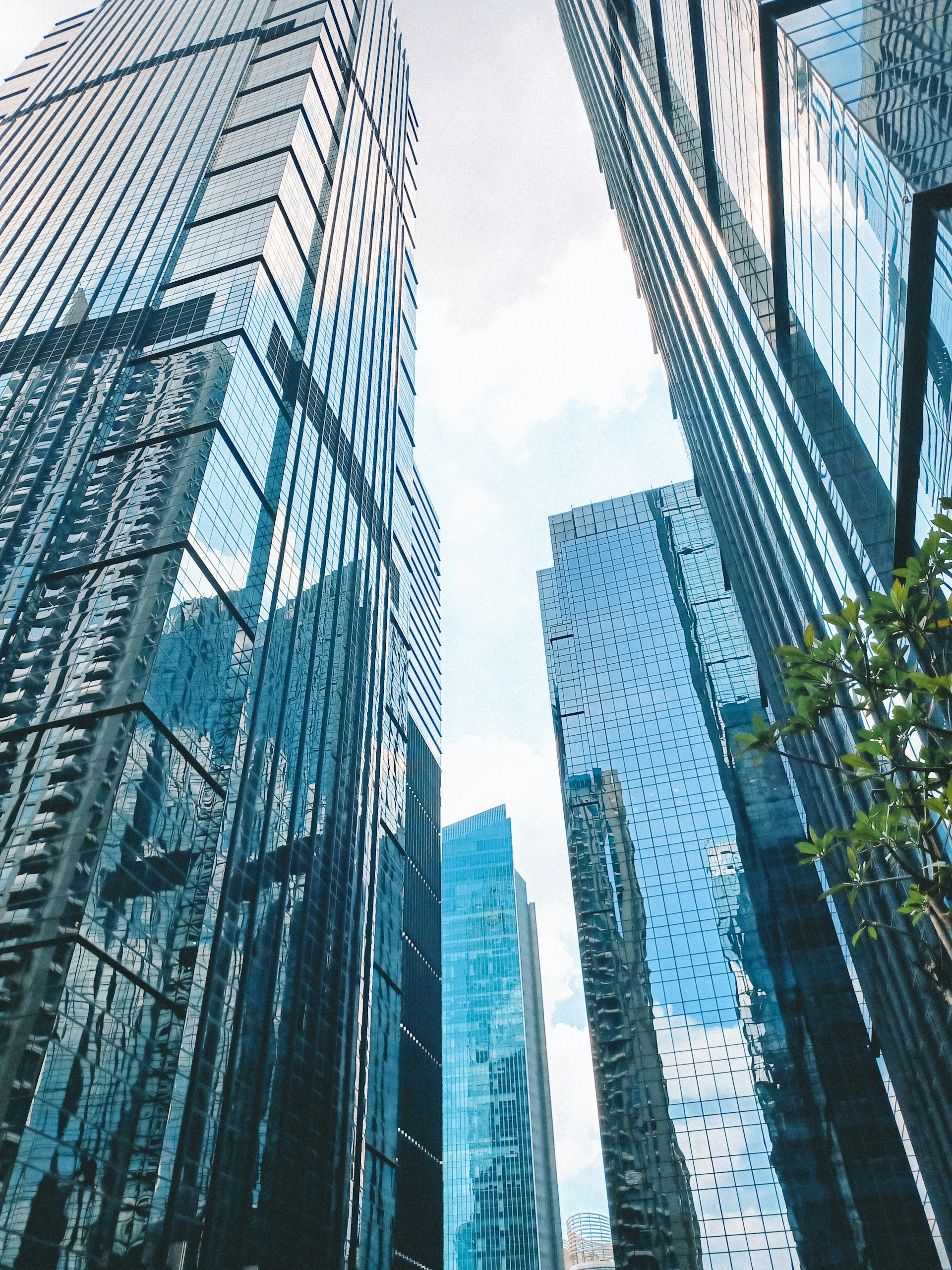a couple of tall buildings sitting next to each other