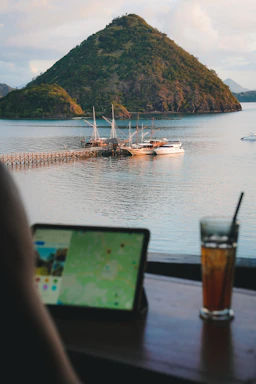 a laptop computer sitting on top of a wooden table