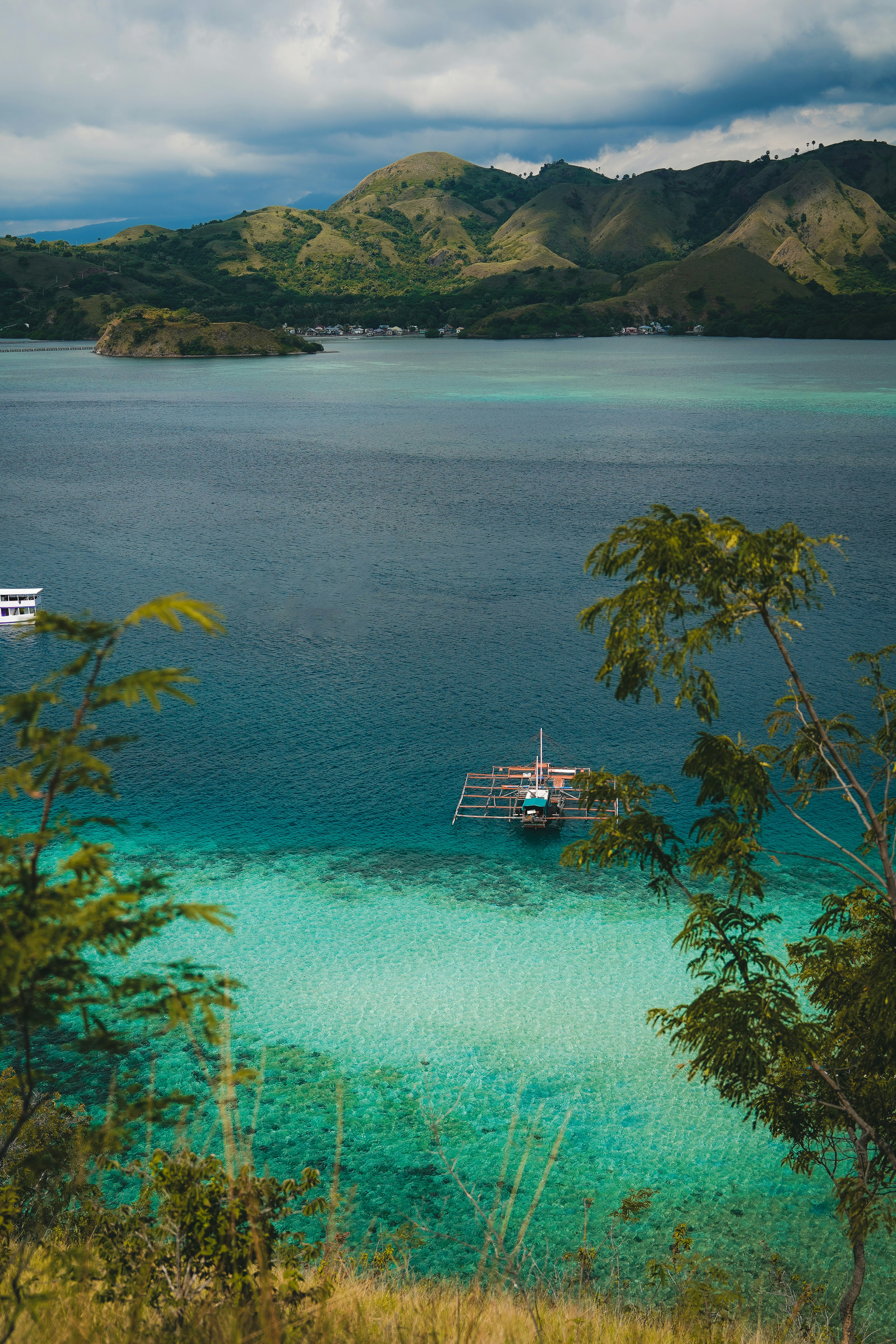 Pristine white sand beach with turquoise waters and traditional Filipino bangka boats in Cebu, Philippines