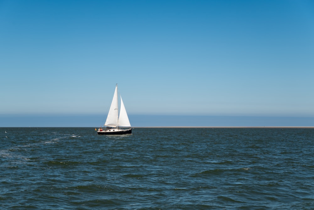 a sailboat sailing across a large body of water