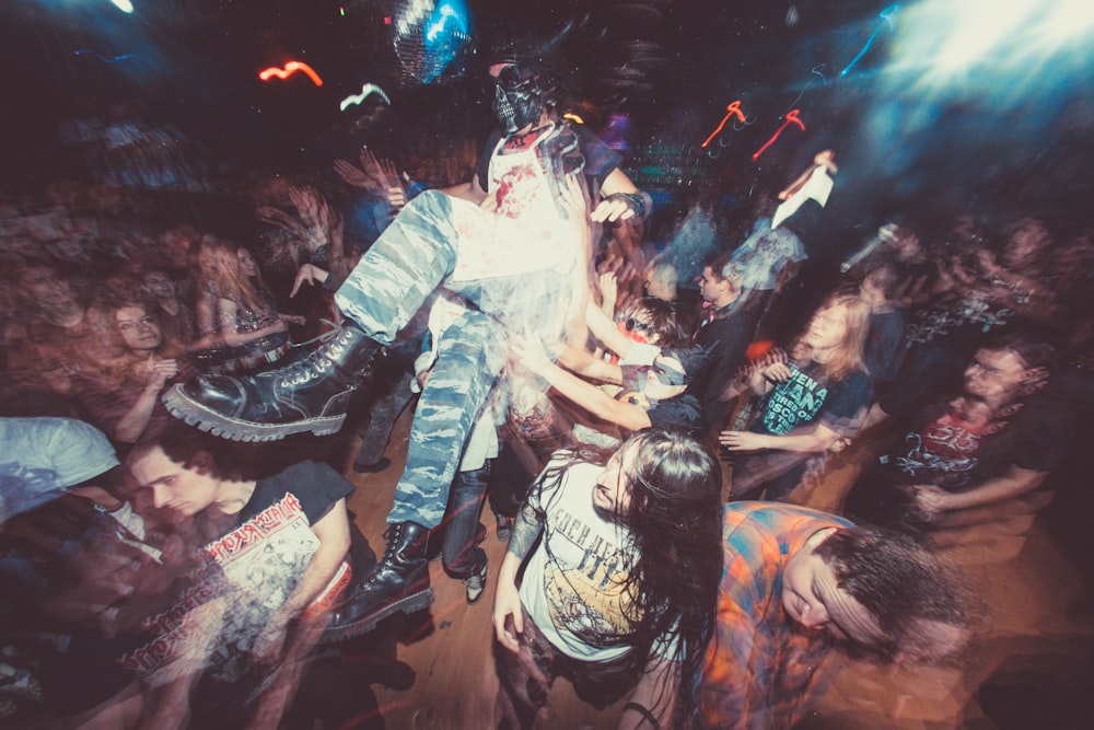 a group of people standing around each other at a concert