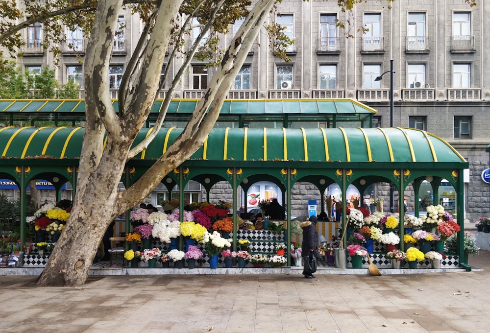 a man is standing in front of a flower shop