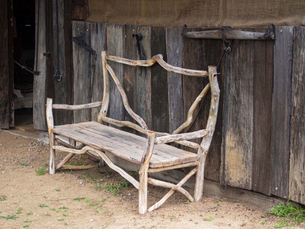 a wooden bench sitting in front of a building