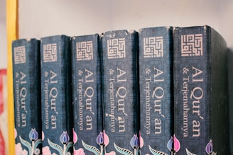 a row of books sitting on top of a shelf