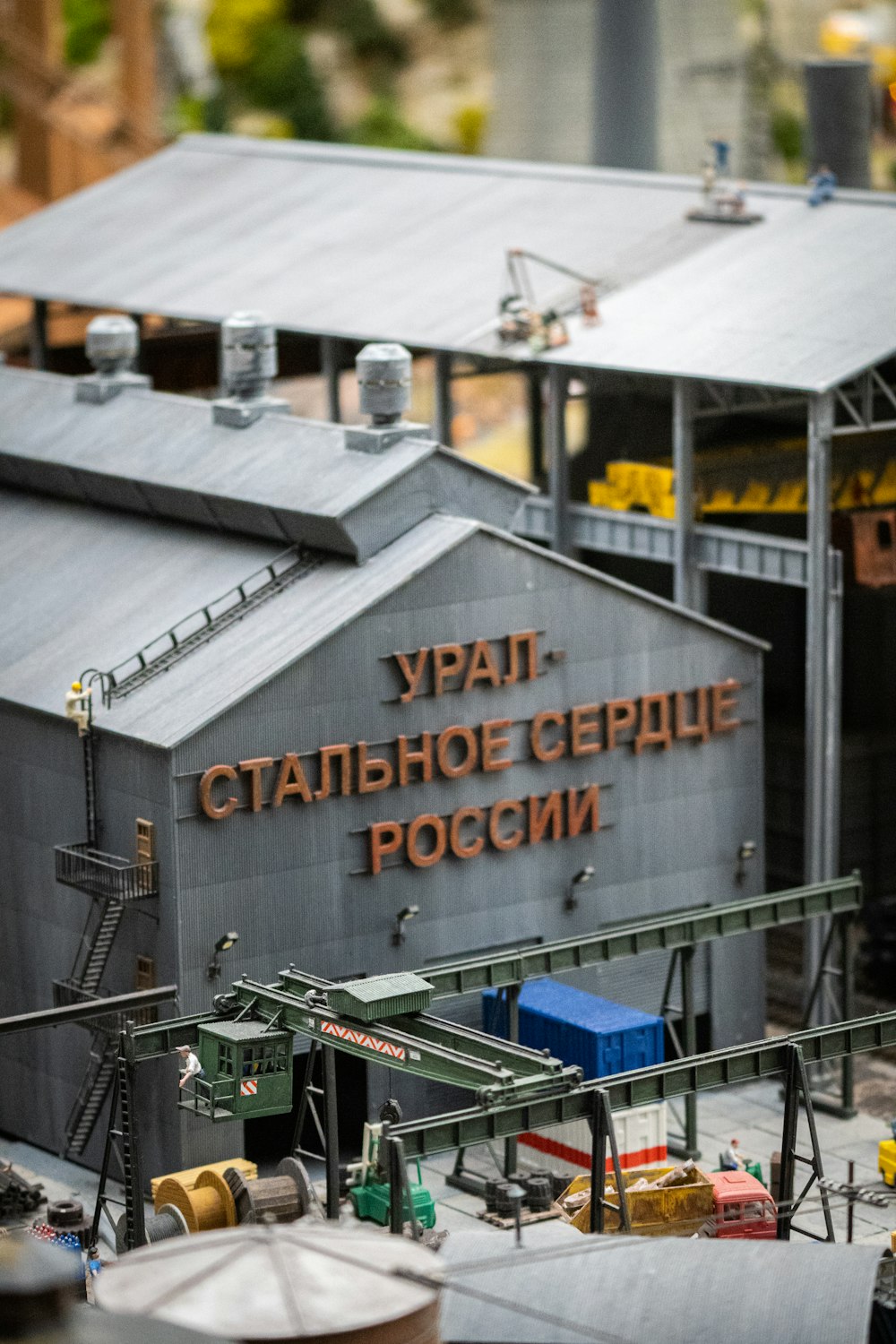 a model of a factory building with a crane in front of it