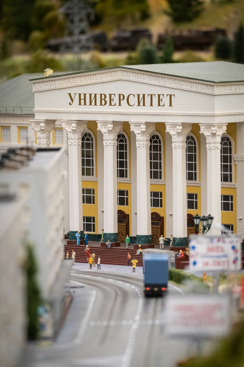 a toy model of a building with a bus in front of it