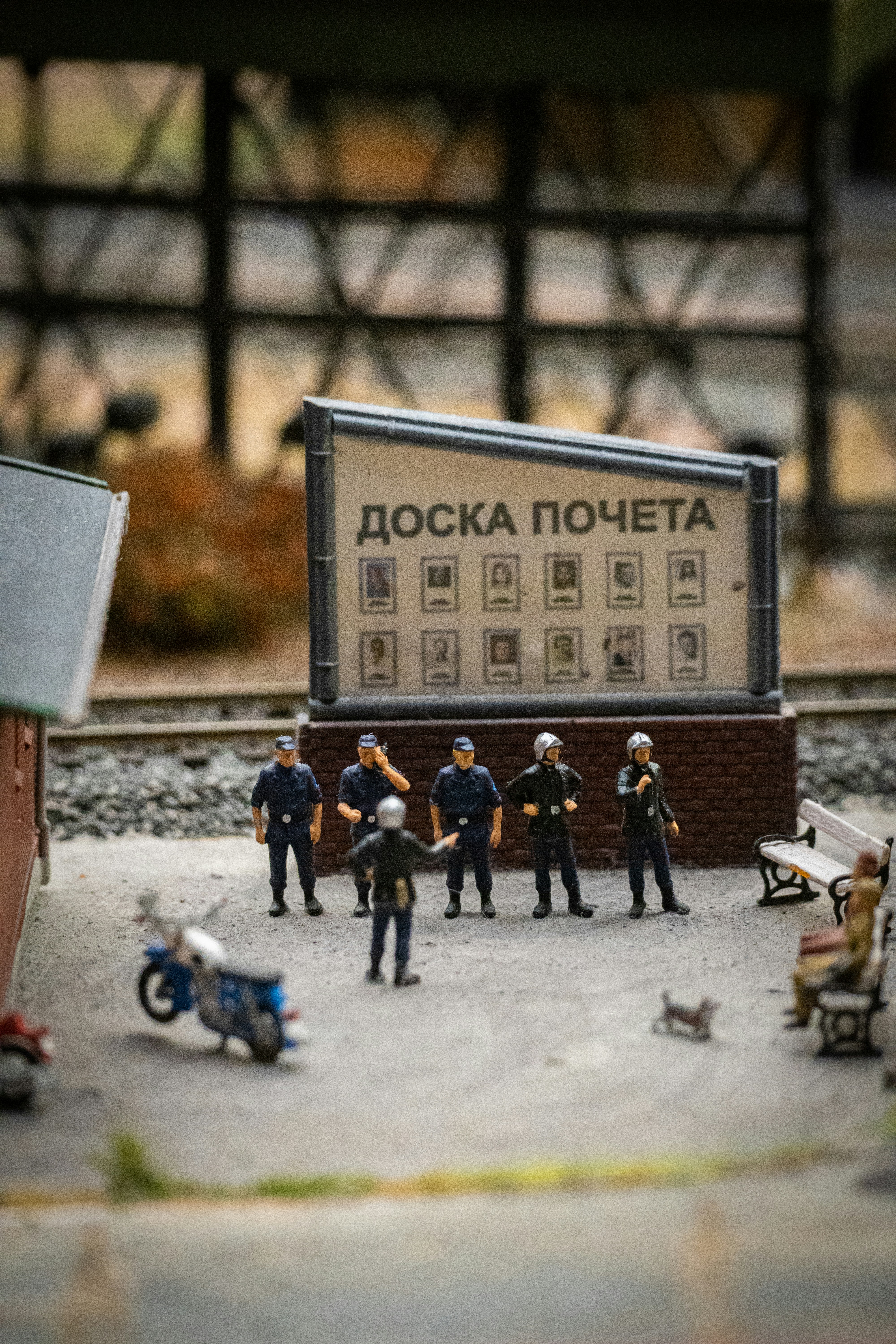 A group of toy police officers standing in front of a sign