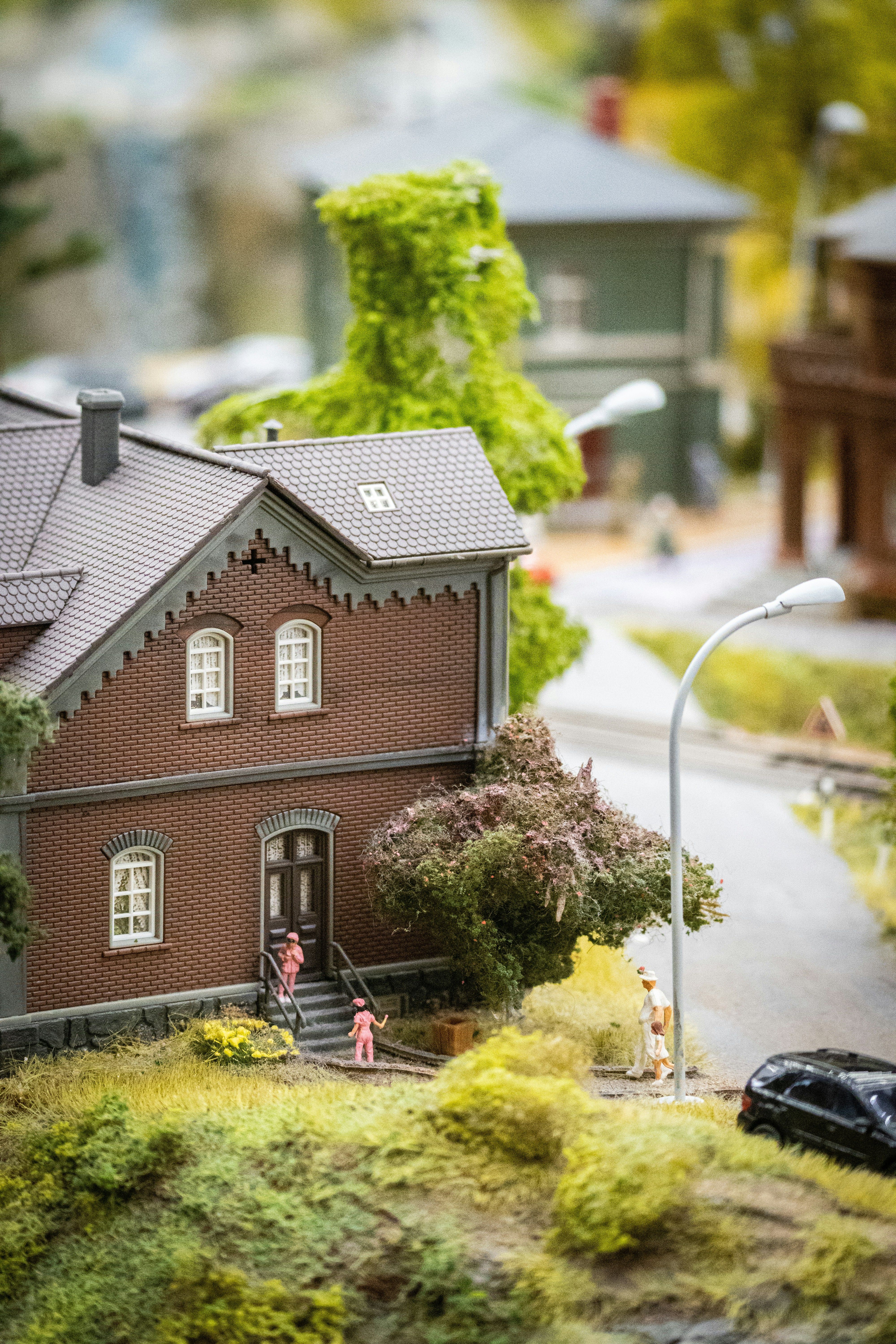 a model of a house with a car parked in front of it
